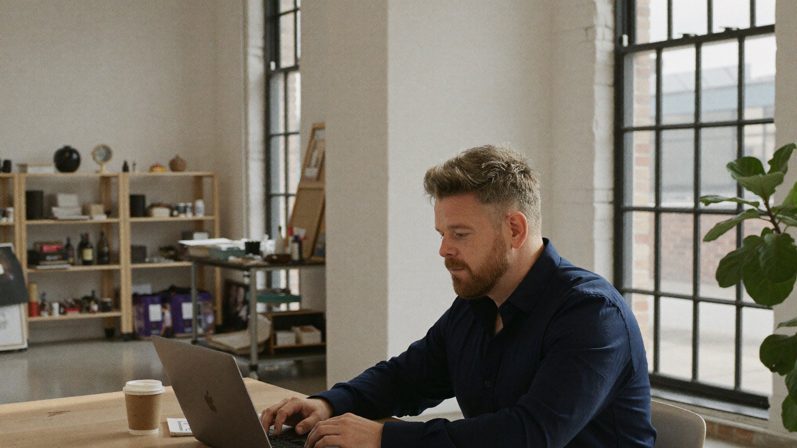 A senior specialist reviewing pinned work in the studio